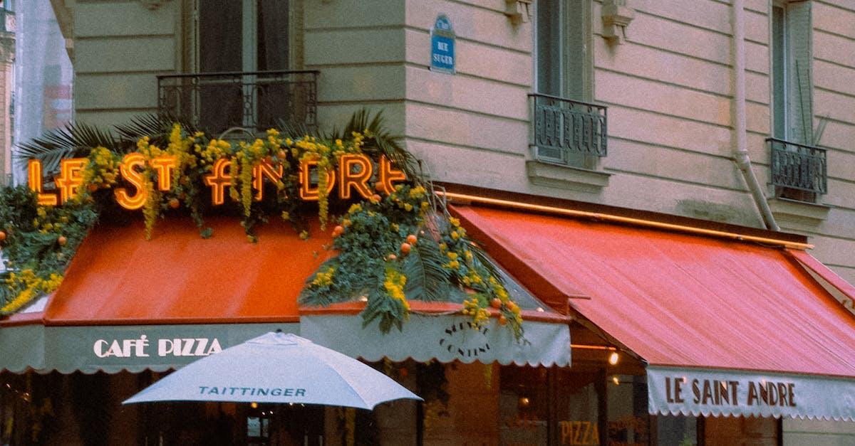 A restaurant with an umbrella and a red awning